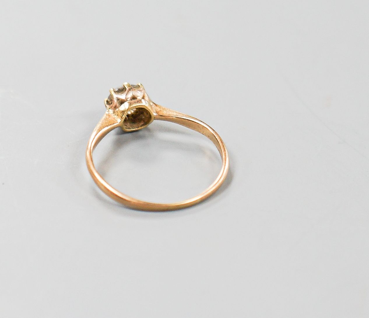 A George V 18ct gold and claw set solitaire diamond ring, size N/O, gross 1.6 grams.